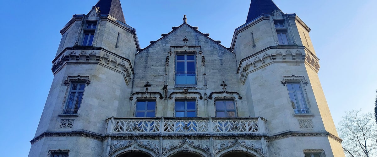 A historic building with two prominent towers and a central entrance.