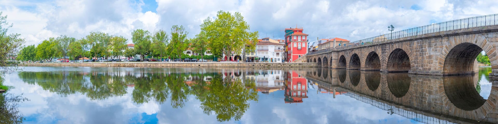 Ponte de Trajano reflected on Tamega river in Chaves, Portugal