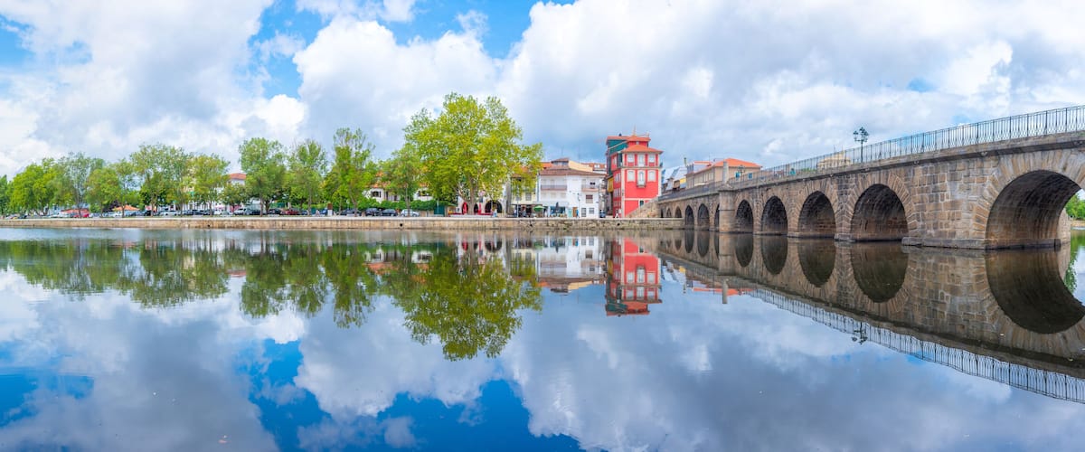 Ponte de Trajano reflected on Tamega river in Chaves, Portugal