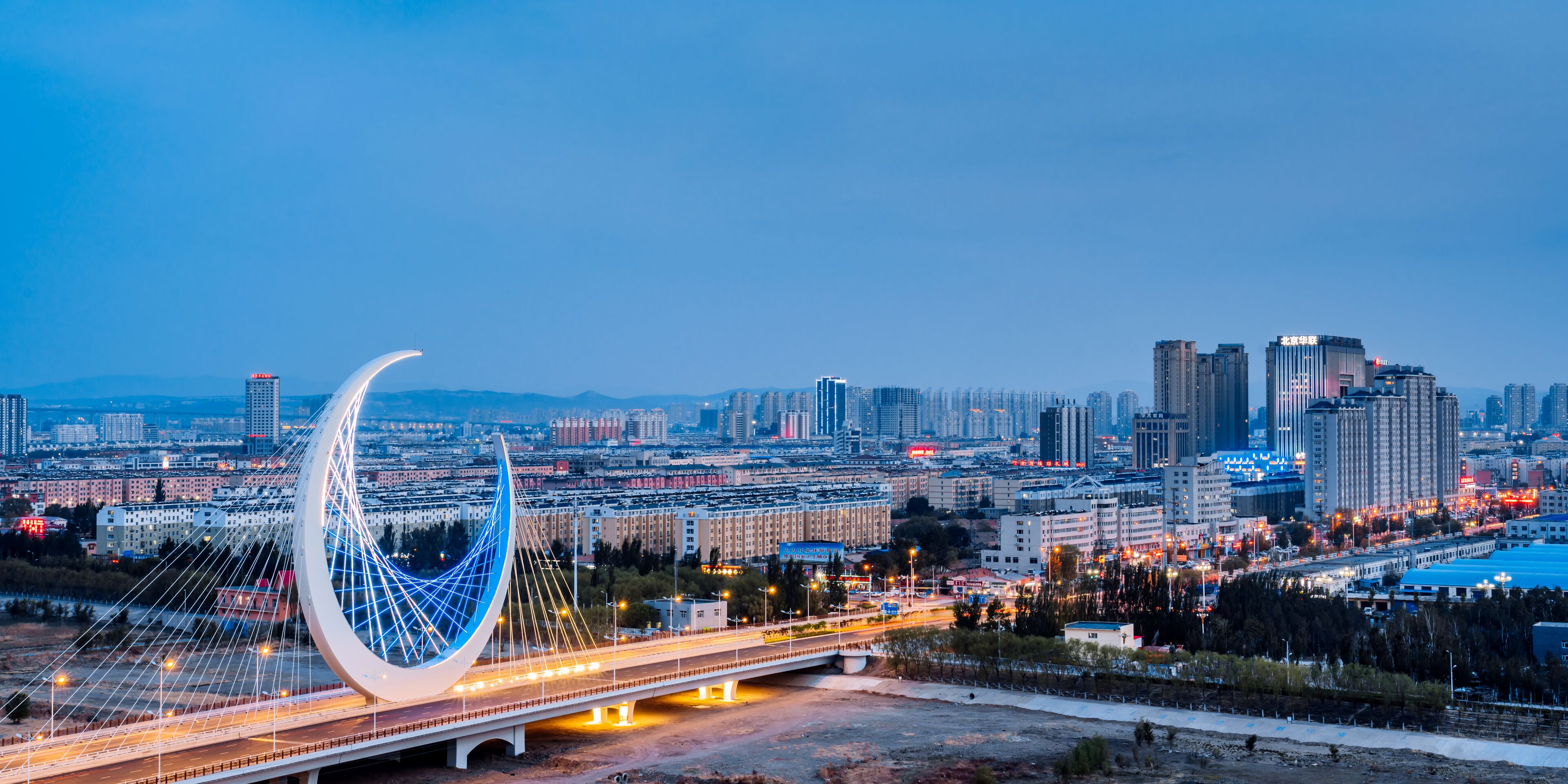 Night view of the urban skyline of the Galaxy Bridge in Chifeng, Inner Mongolia, China