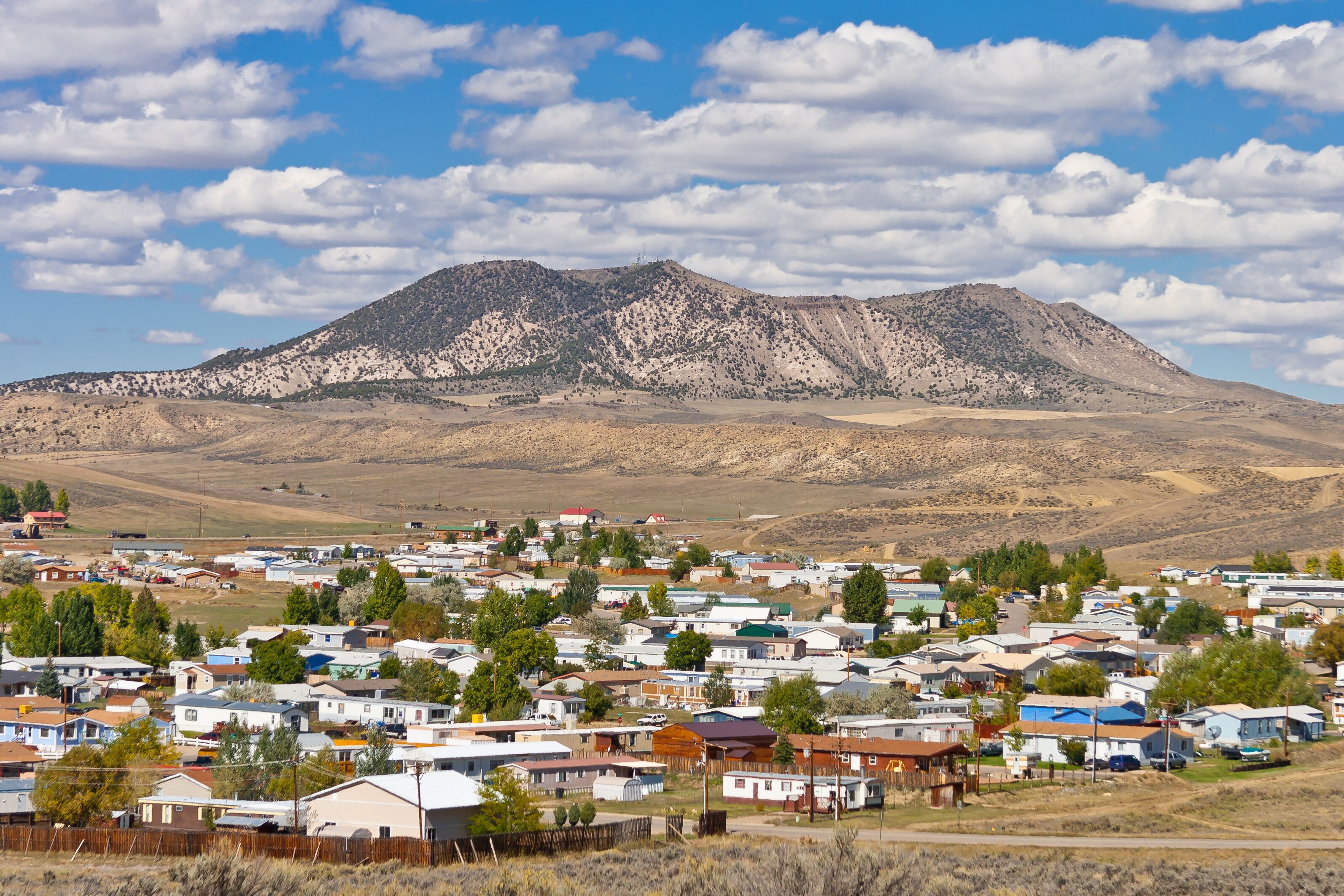 A town with mobile homes and a mountain in the background.
