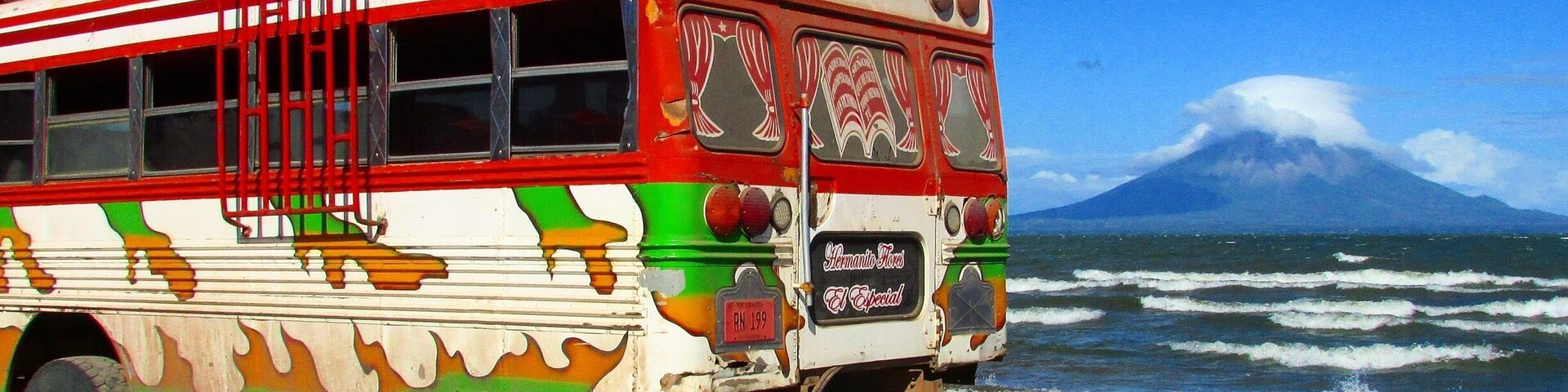 This festive bus is parked on the beach in front of Ometepe island and Concepcion Volcano. A unique Nicaragua experience! Not your typical beach day. #BeachBound