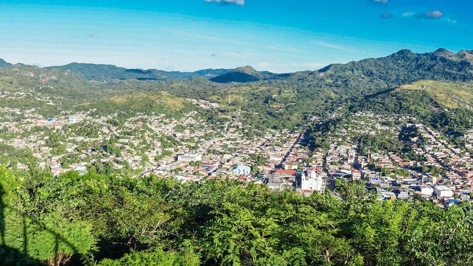A mountainous landscape with a town nestled in the valley.