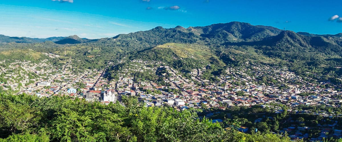 A mountainous landscape with a town nestled in the valley.