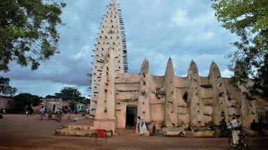 A traditional building with a tall, pointed tower and multiple smaller towers.
