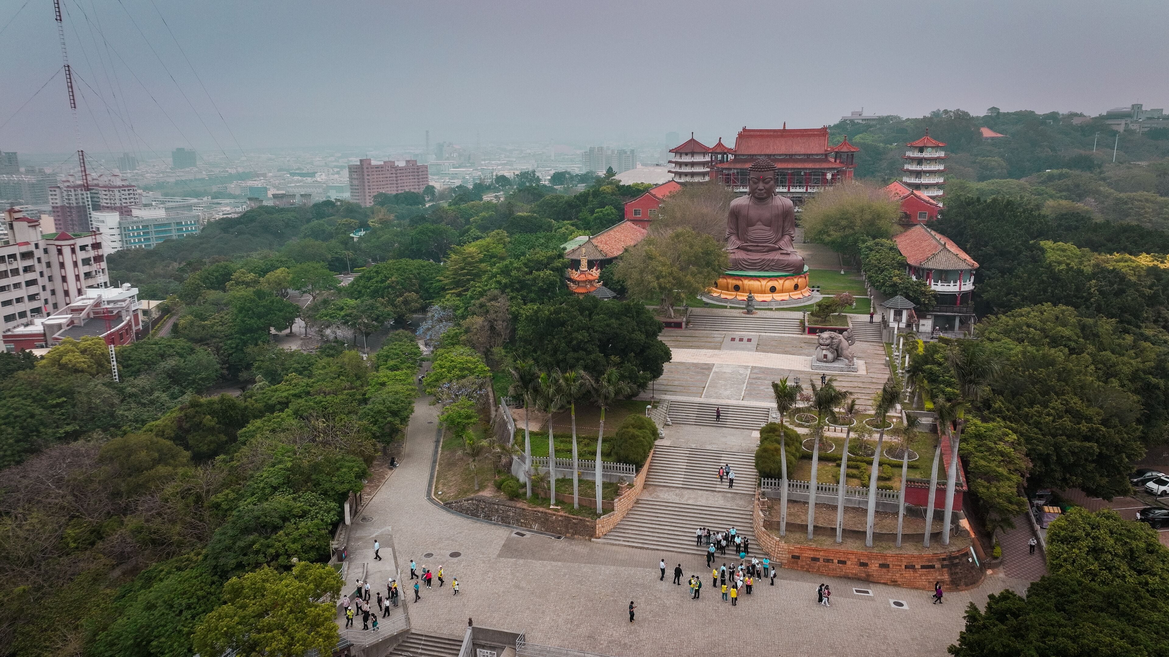 View of the large Buddha statue amidst lush greenery in Changhua, Taiwan on a cloudy day