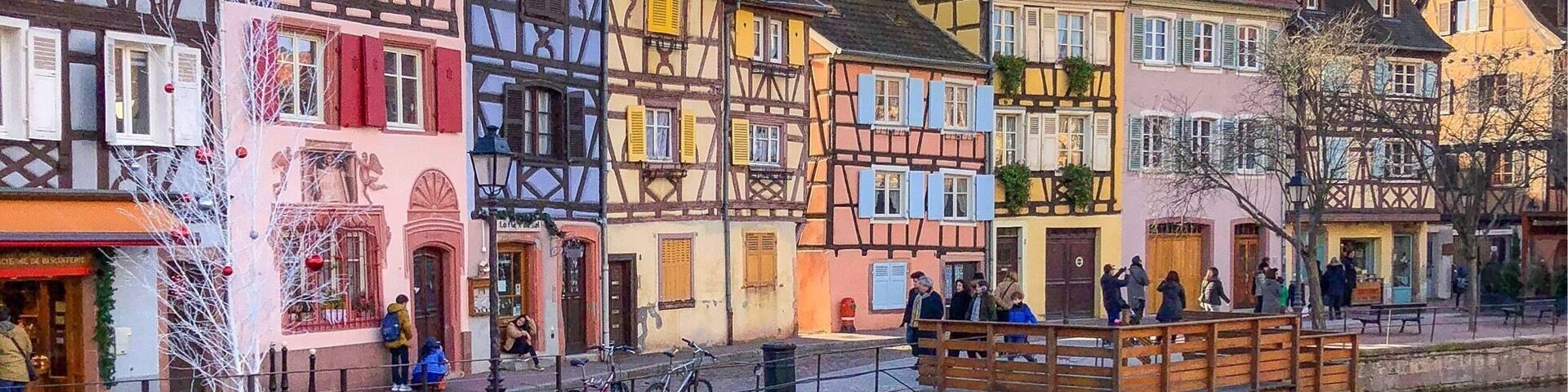 A picturesque European town with colorful half-timbered houses along a canal.