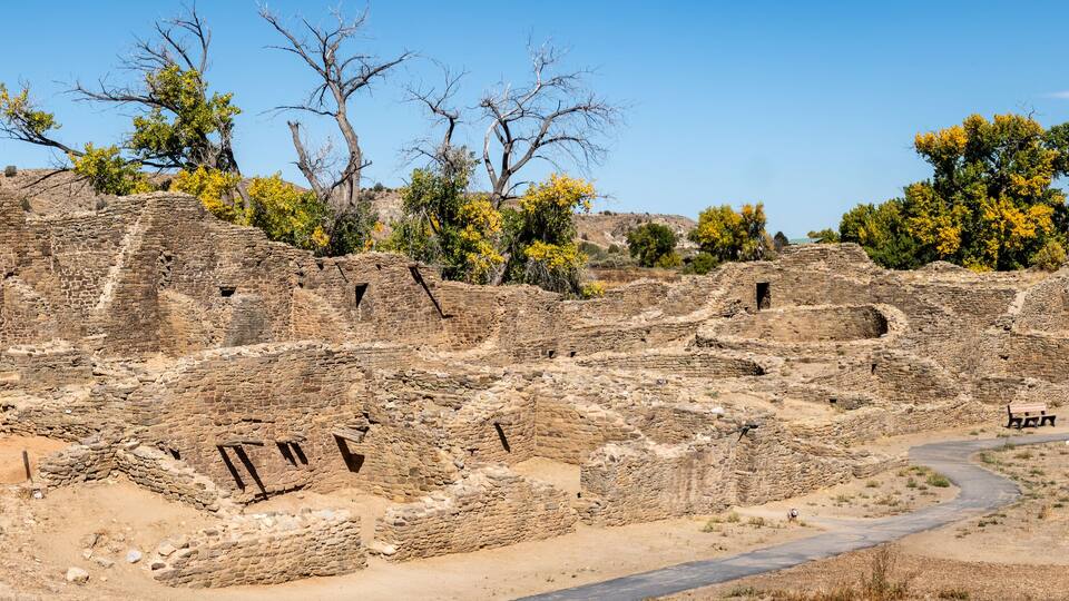 Ancient ruins with stone walls and a winding path.