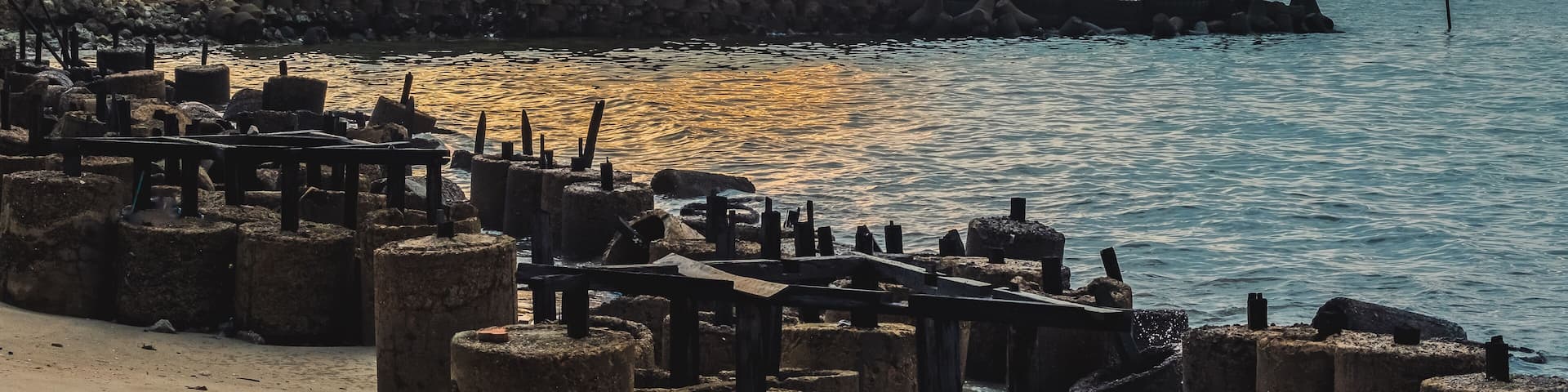 Fishing in the Morning, a group of people fishing on a rocky shore next to the sea on Sunday morning.