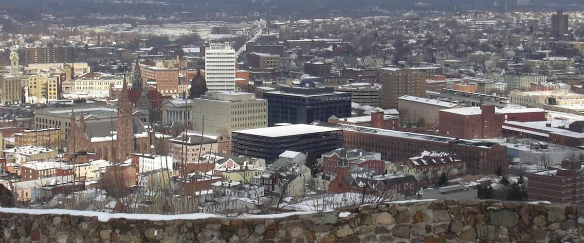 A snow-covered cityscape with historic buildings and modern architecture.