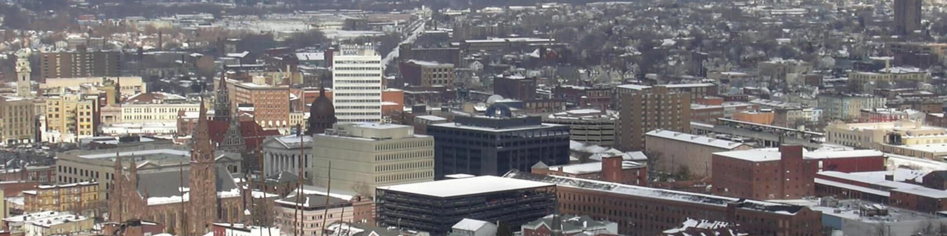 A snow-covered cityscape with historic buildings and modern architecture.