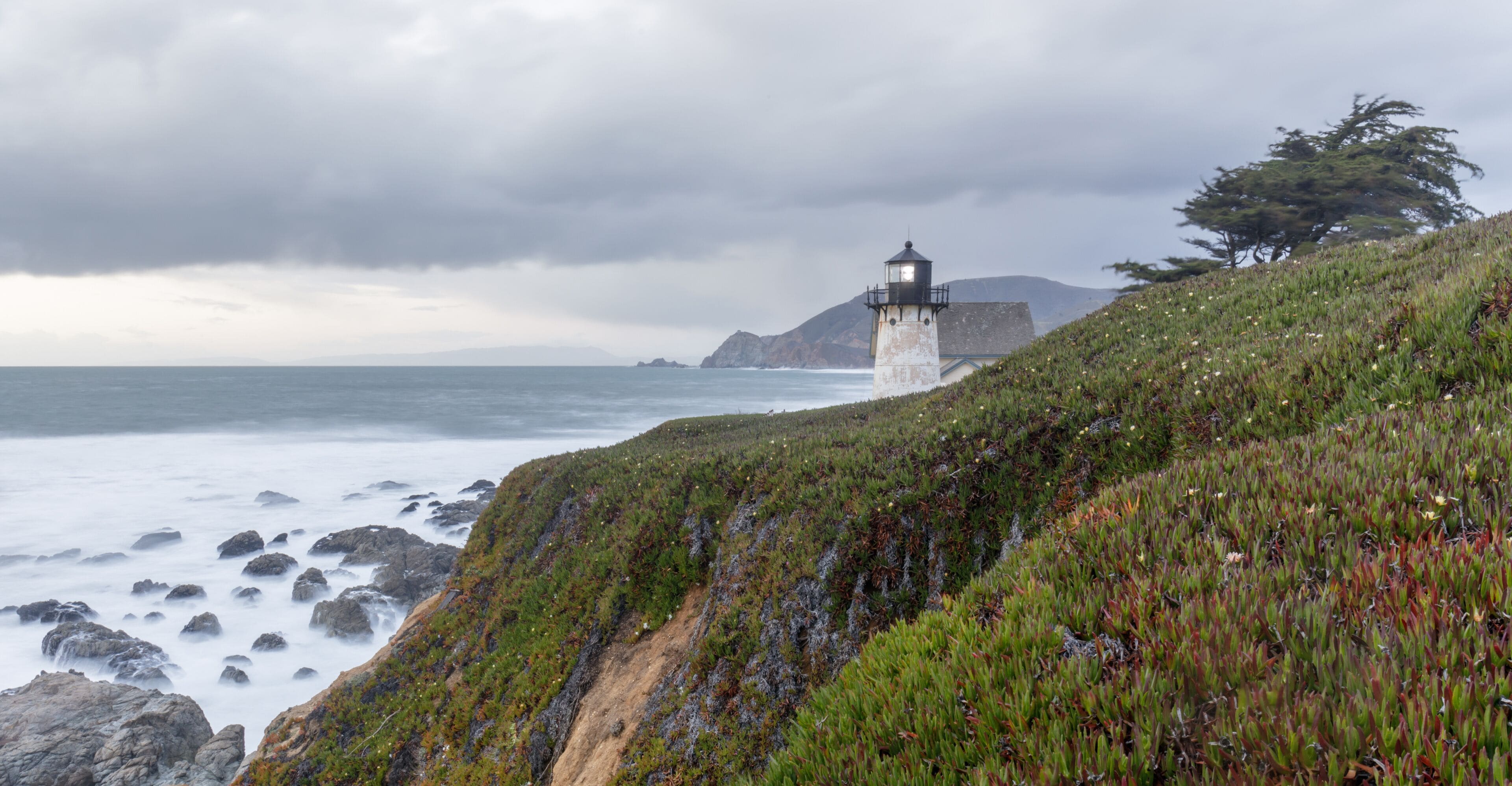 Point Montara Lighthouse and the Pacific Ocean Coastline on a winter evening. Montara, San Mateo County, California, USA.