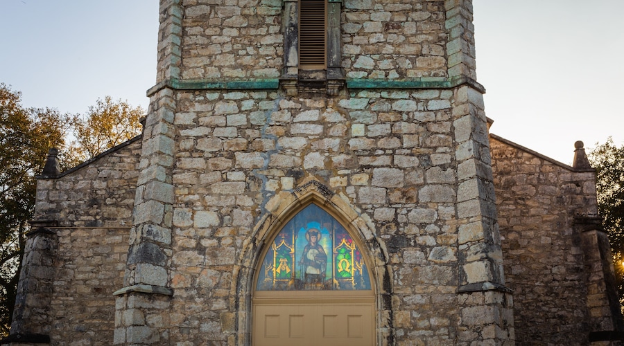 Sun shining through stained glass at St. Louis Catholic Church in Castroville was built in 1867 with local limestone. The Parish was established in 1844 with the earliest settlement of the town.