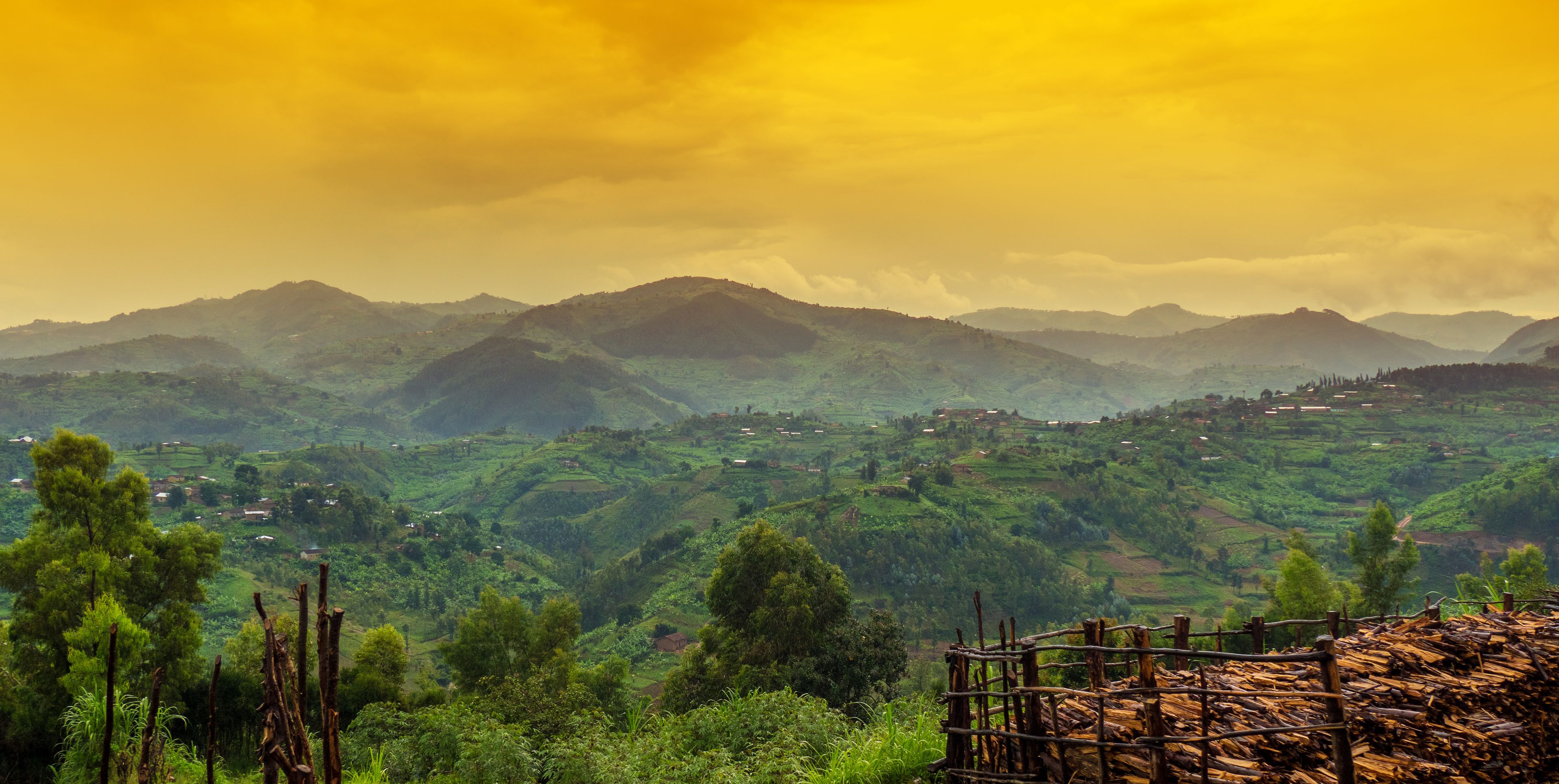 A mountainous landscape with scattered houses and lush greenery.