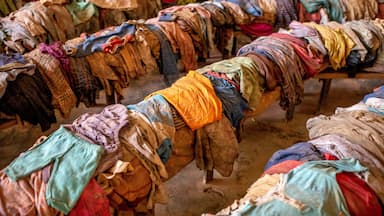 A market with rows of clothing on display.