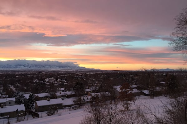 This is a northwest view of the Oquirrh Mts on the west side of Salt Lake Valley. They are covered by low hanging clouds as well as higher ones. Off to the right is Antelope Island in the Great Salt Lake.