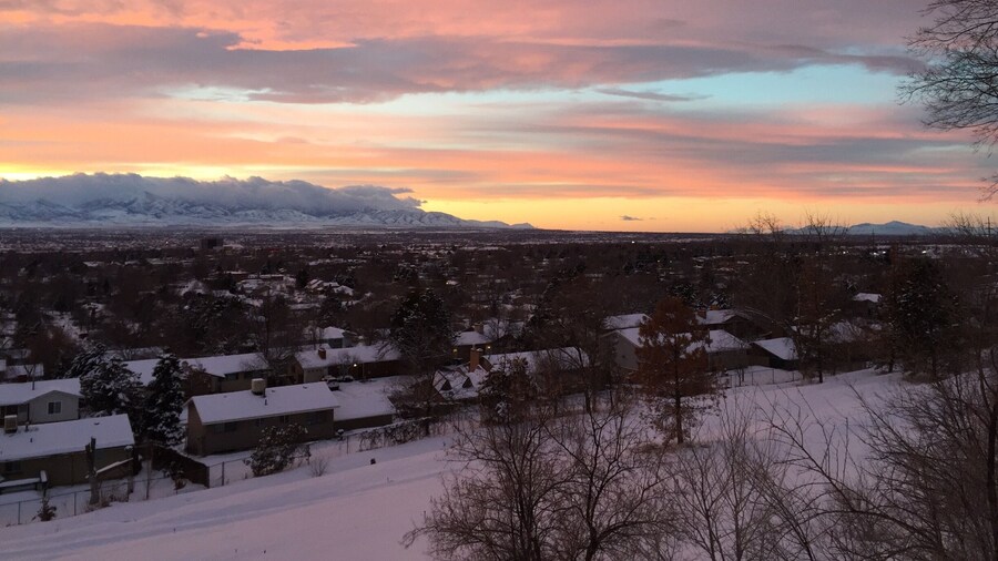 This is a northwest view of the Oquirrh Mts on the west side of Salt Lake Valley. They are covered by low hanging clouds as well as higher ones. Off to the right is Antelope Island in the Great Salt Lake.