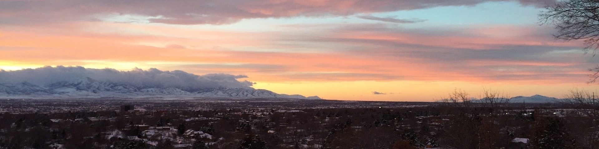 This is a northwest view of the Oquirrh Mts on the west side of Salt Lake Valley. They are covered by low hanging clouds as well as higher ones. Off to the right is Antelope Island in the Great Salt Lake.