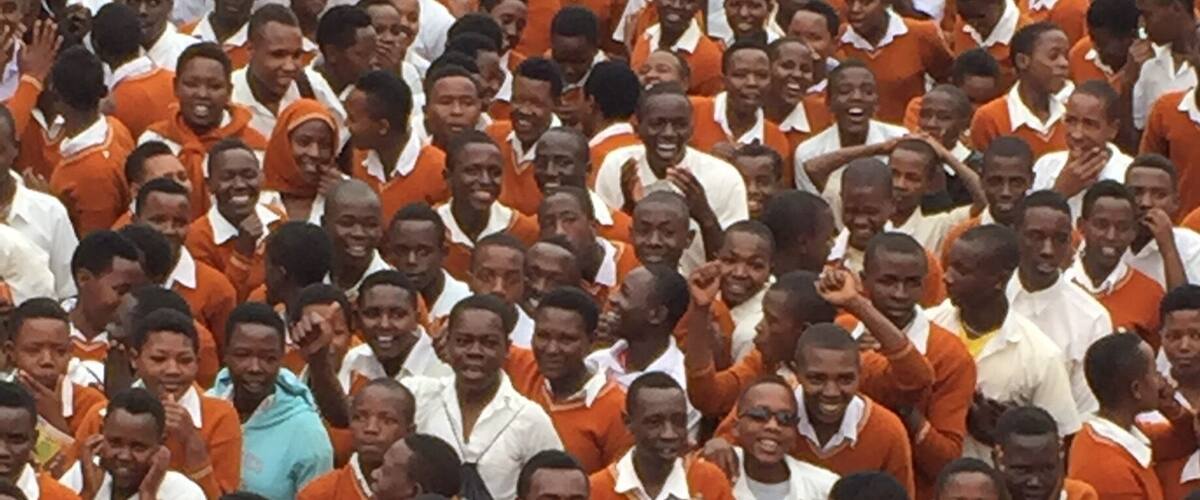 A crowd of children in orange uniforms.