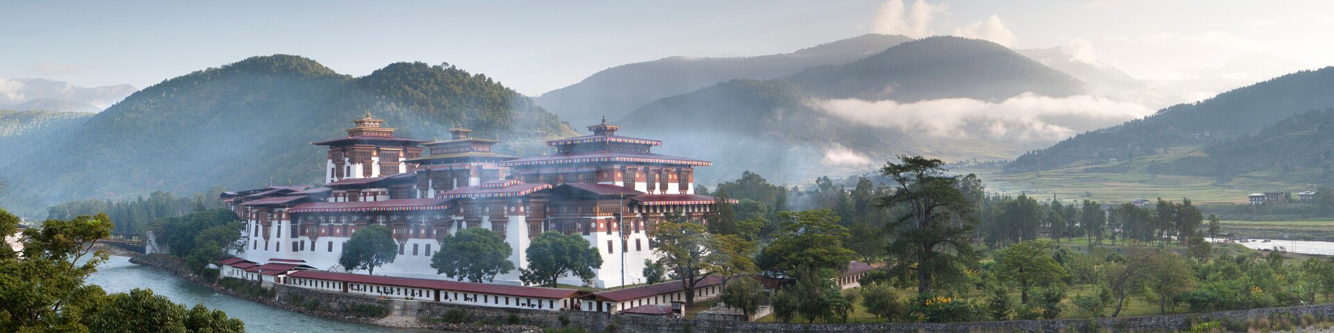 Misty dawn view of the Punakha Dzong located at the junction of the Mo Chhu (Mother River) and Pho Chhu (Father River) in the Punakha Valley, Bhutan, Himalayas