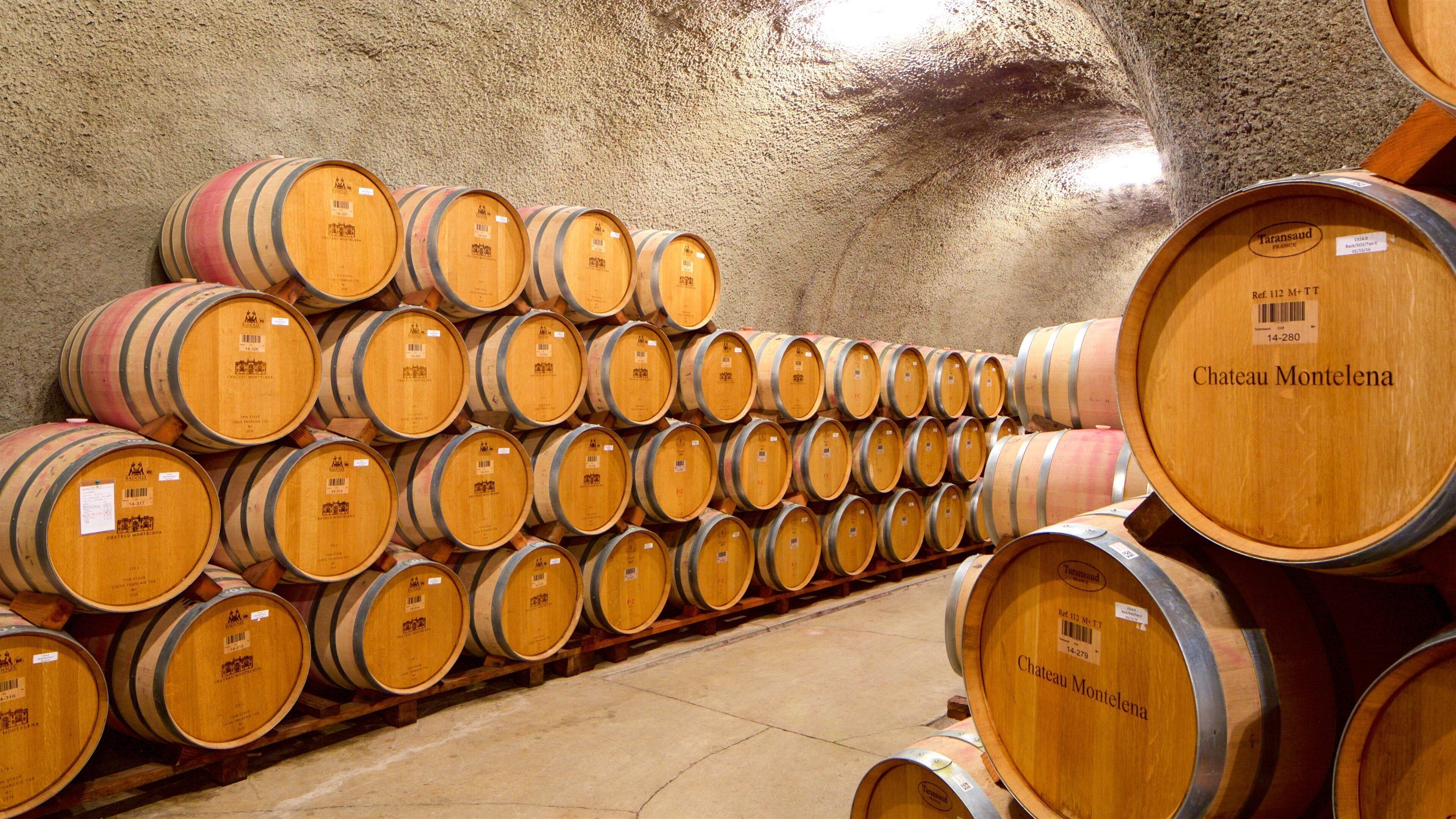 Wooden wine barrels stacked in a warehouse.