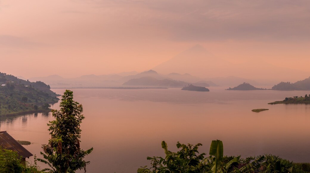 Panorama of Lake Mutanda at morning with view on the volcanoes mount Muhavuru and mount Gahinga in East Africa, along the border of Rwanda and Uganda.