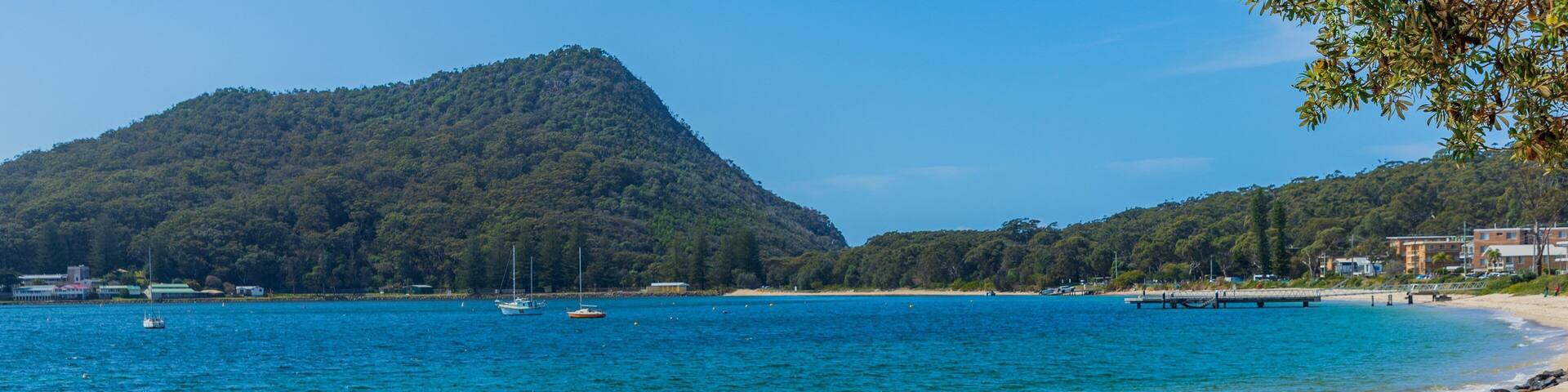 Shoal Bay Beach showing general coastal views and a sandy beach as well as an individual femail