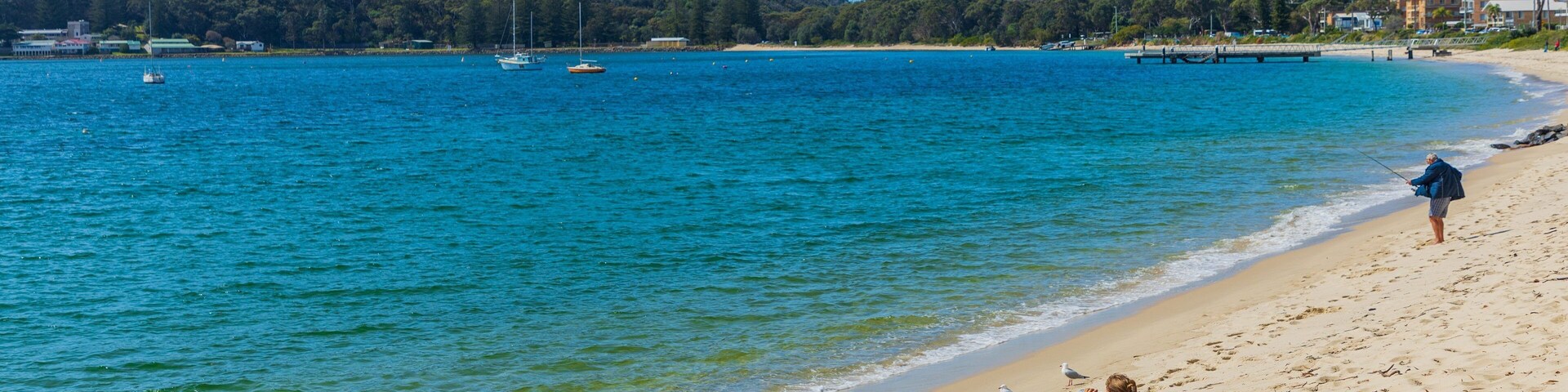 Shoal Bay Beach showing general coastal views and a sandy beach as well as an individual femail