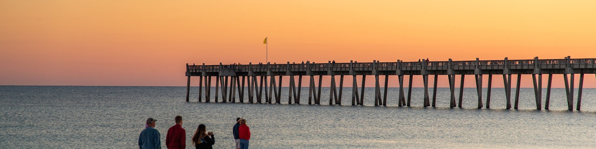 Pensacola Beach which includes a beach, a sunset and general coastal views