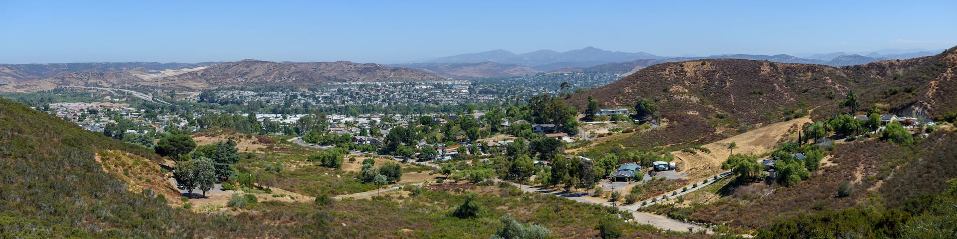 Panoramic view from Mesa Trail overlooking Santee, with dry hills and distant mountains under a clear sky