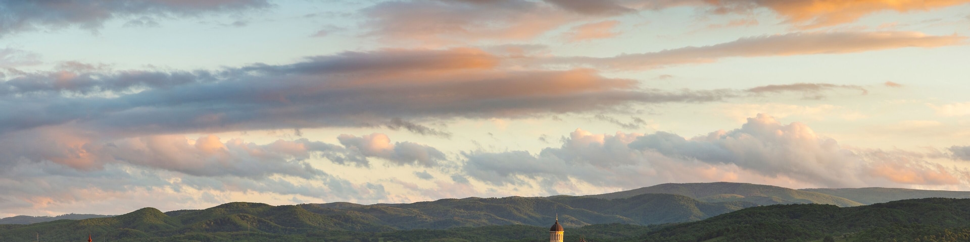 Majestic sunset with colorful clouds above the city of Caransebes