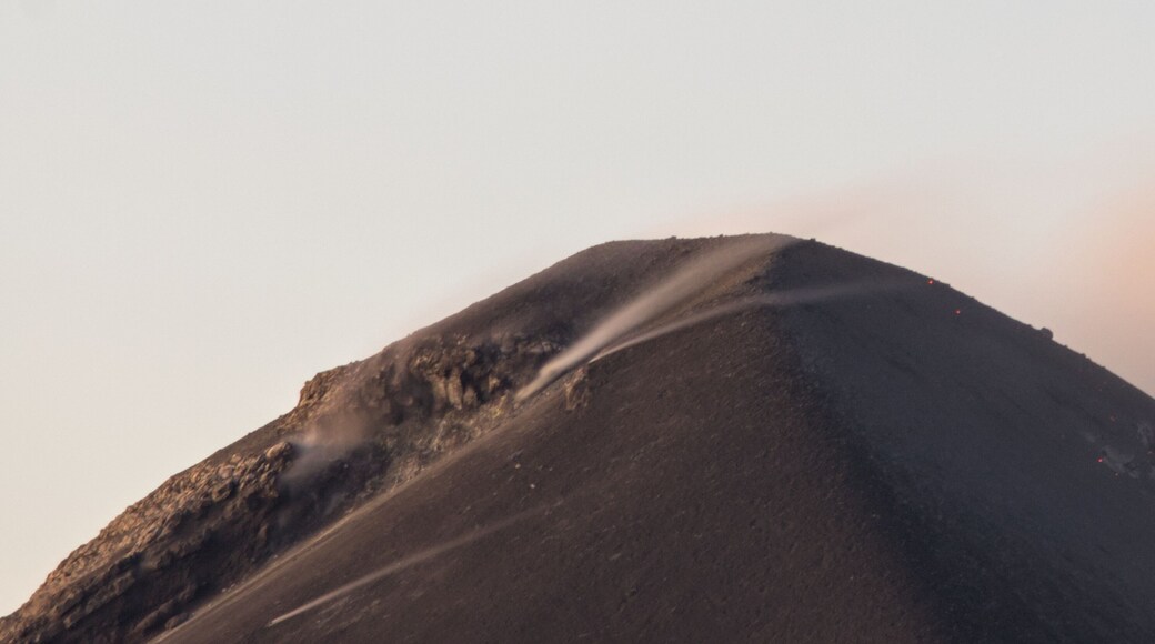 view of active volcano fuego from the top of hiking trail acatenango in antigua guatemala (scenic tree forest view of smoke lava erupting seismic activity) trail hike adventure outdoor travel tourism