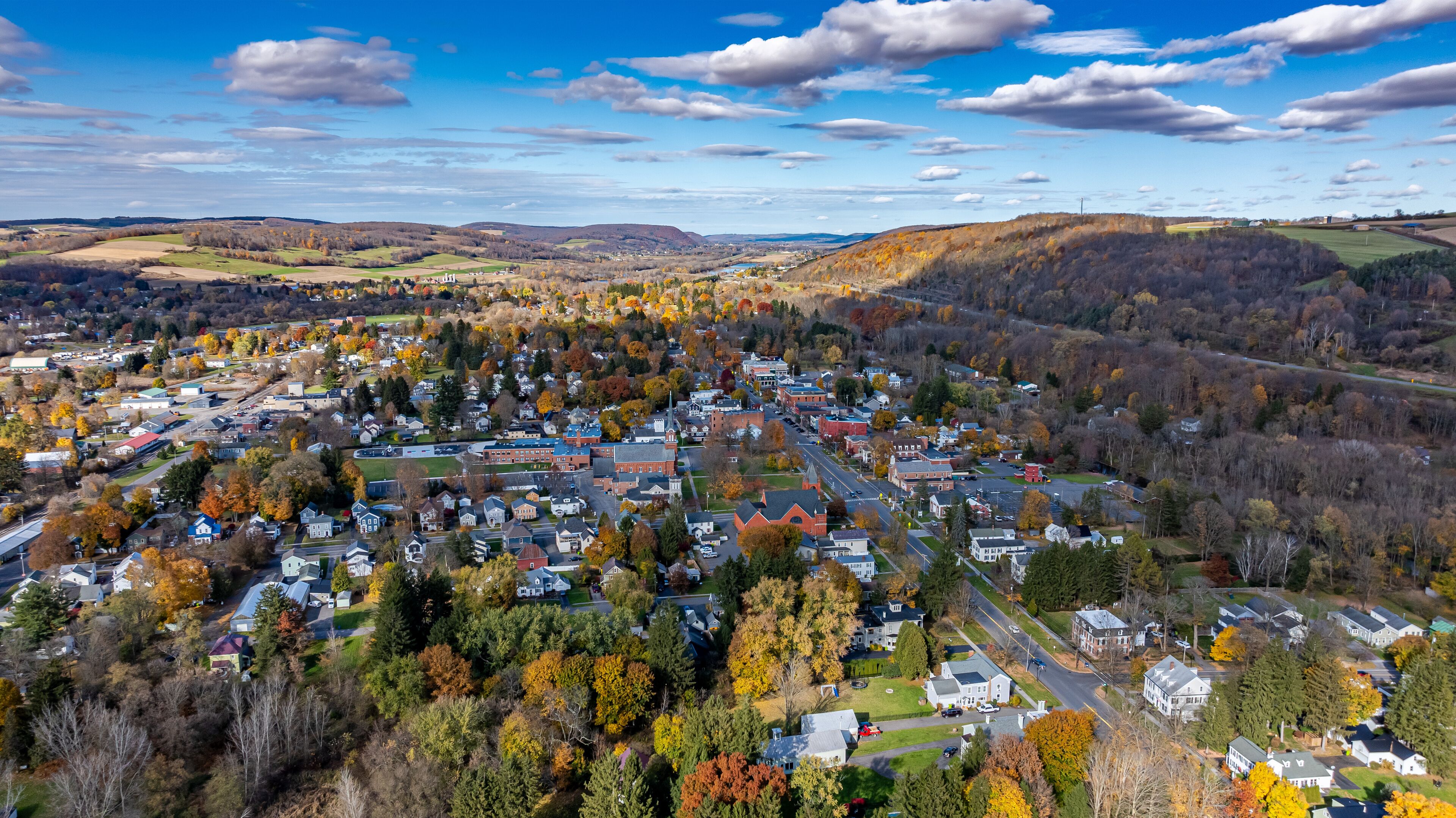 Aerial photo of fall foliage surrounding the Village of Homer, Cortland County, New York State, October 2024.	