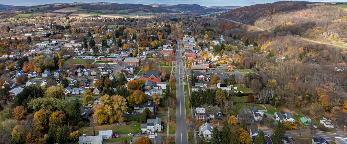 Aerial photo of fall foliage surrounding the Village of Homer, Cortland County, New York State, October 2024.