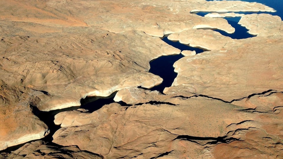 A vast arid landscape with multiple water bodies and rugged terrain.