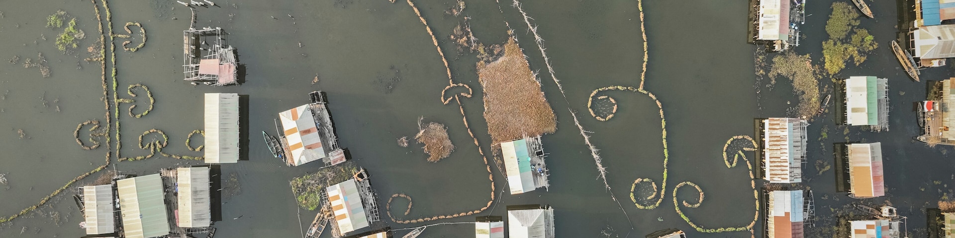 Aerial view of a vibrant fishing village with colorful houses and waterways, Atlantique, Benin.