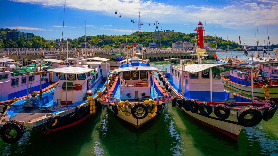 Fishing trawlers moored at Hamel Lighthouse harbor under the cable cars in Yeosu City, South Korea