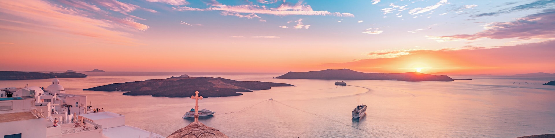 Amazing evening view of Fira, caldera, volcano of Santorini, Greece with cruise ships at sunset. Cloudy dramatic sky