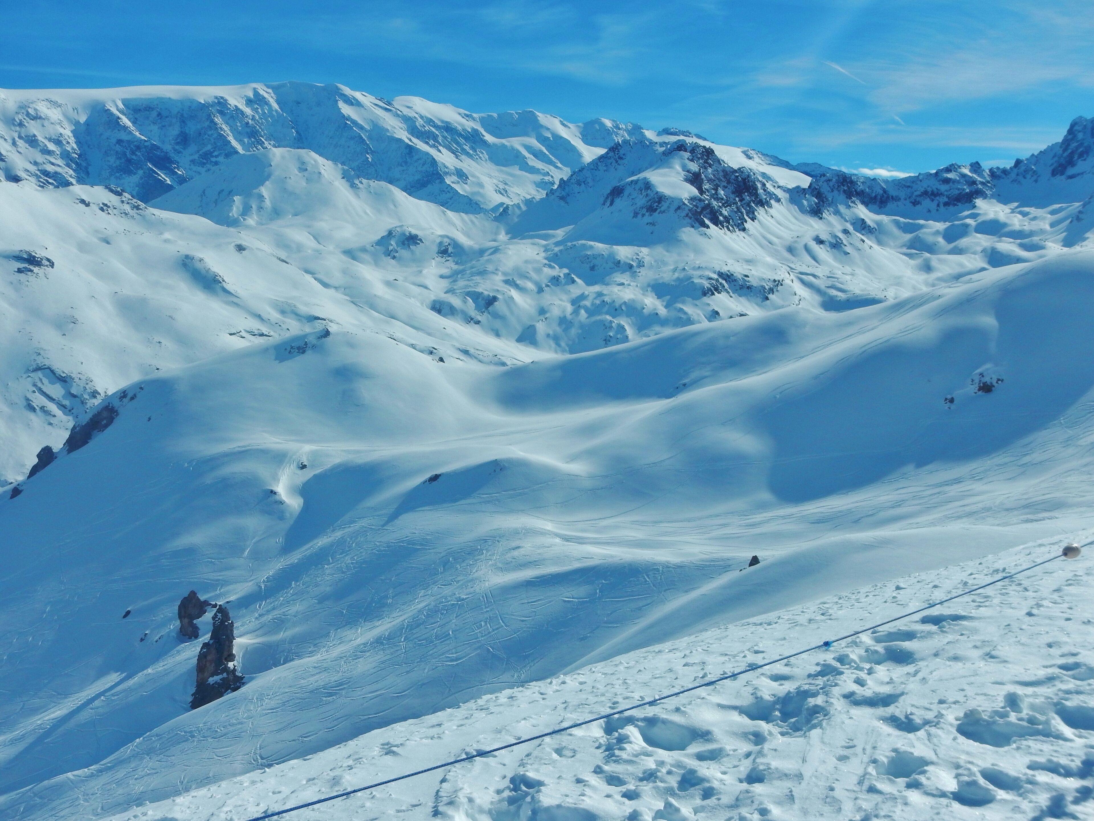 A snow-covered mountain landscape with a clear sky.