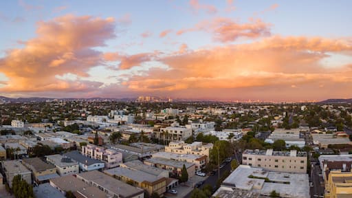 Aerial view of the Mar Vista neighborhood with the city of Los Angeles and the Santa Monica mountains in the background. Take during sunset with a drone.