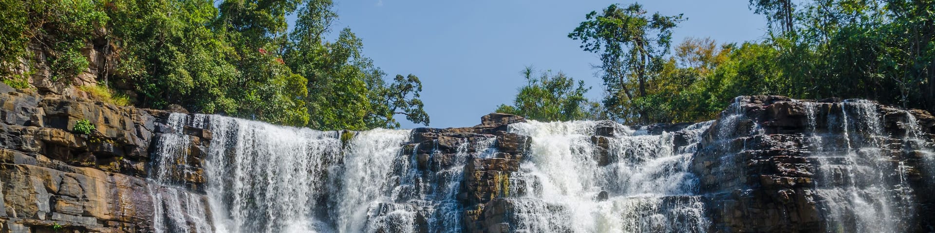 Beautiful Sala water falls near Labe with trees, green pool and a lot of water flow, Guinea Conakry, West Africa
