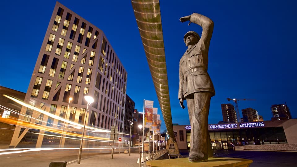 A statue of a man in uniform, a modern building, and the Transport Museum sign.