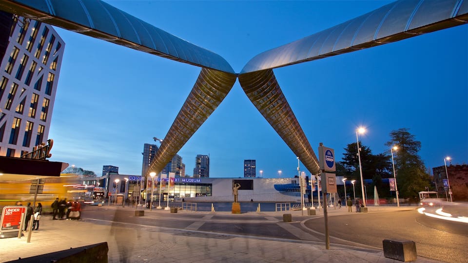A city intersection with a distinctive bridge structure and a museum.