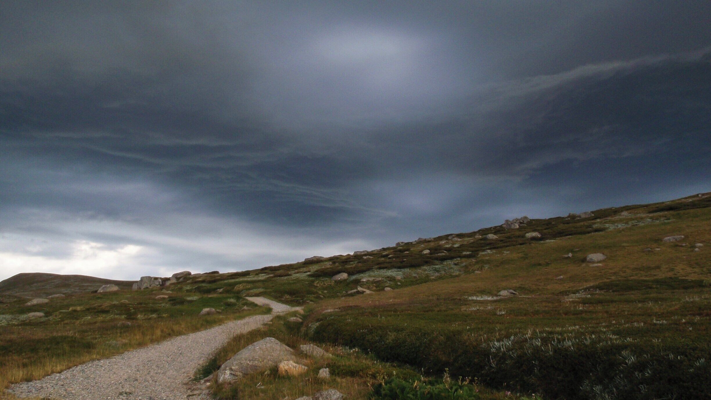 On Australian Day 2012 I walked the Main Range Track in Mt Kosciuszko National Park with friends. Its a loop track from Charlotte Pass to Mt Kosciuszko return. It was the most perfect day for a 20 kilometre walk and we were treated to some spectacular views. Just after we started the walk these clouds loomed up in front of us. The air electric , however they passed by with just a drop or two of rain.
 
