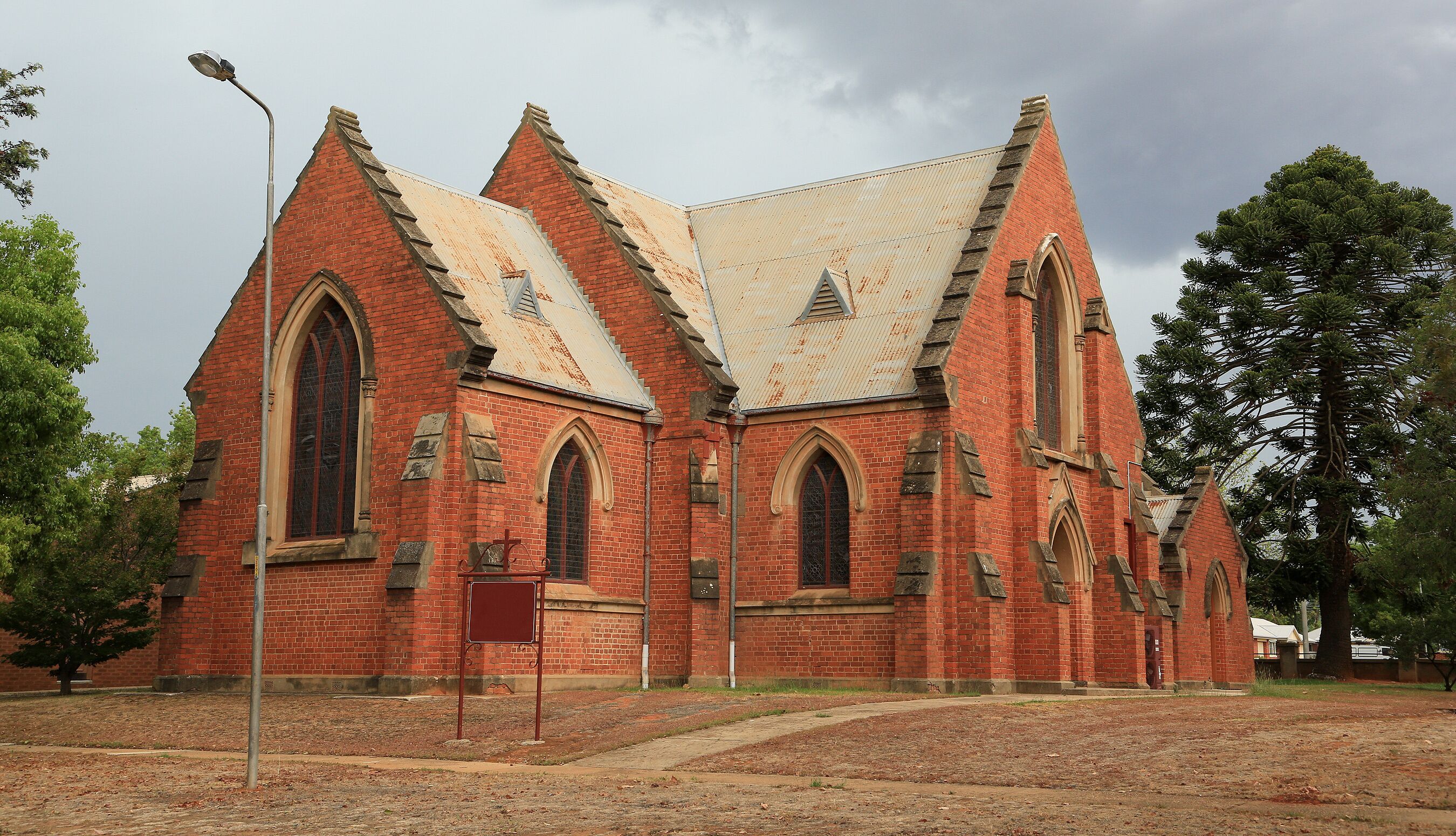 A red brick church with pointed arches and a steeply pitched roof.