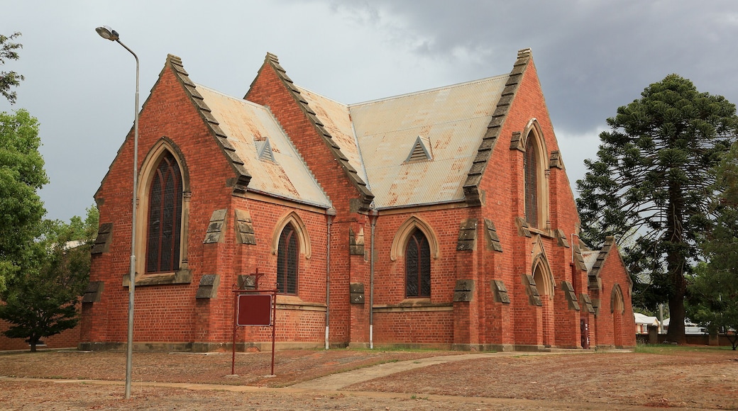 Una iglesia de ladrillo rojo con arcos apuntados y un techo empinado.