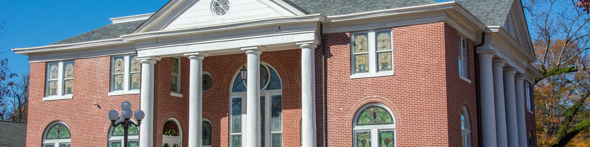 A red brick building with a large dome and columns.