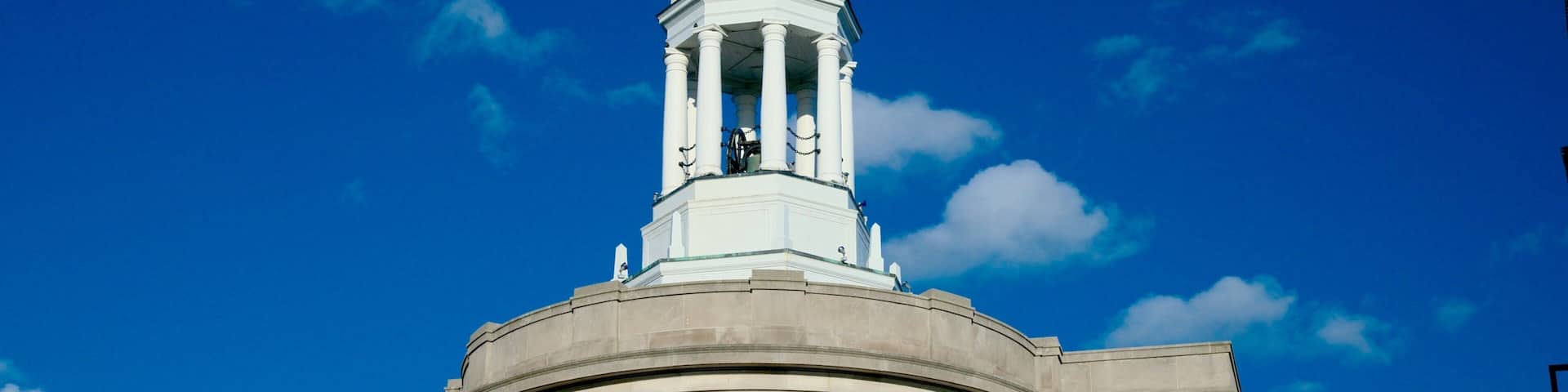 A large building with a dome and a clock tower.