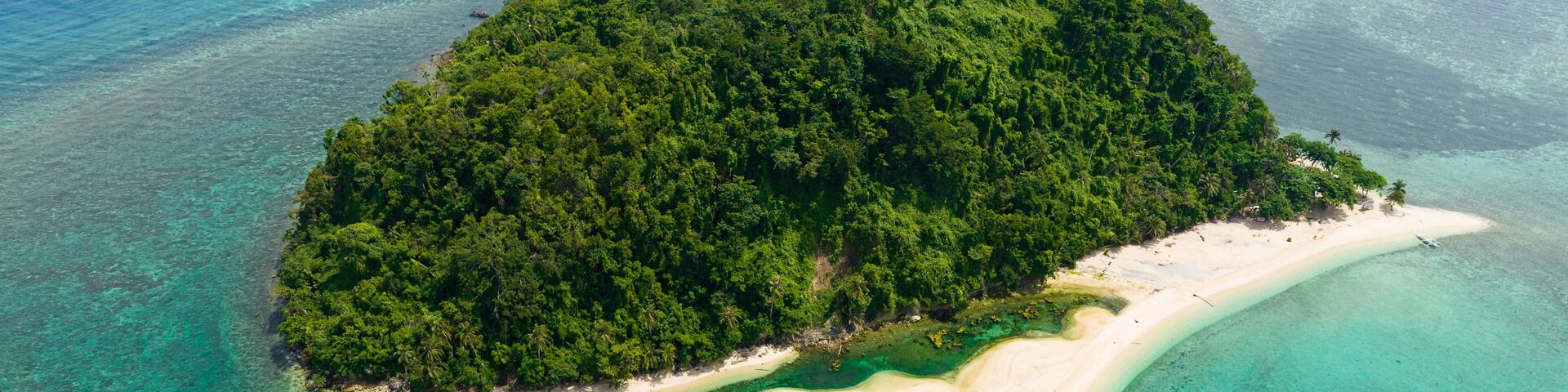Top view of island in the blue sea with atoll and the beach. Agutaya island, Philippines.