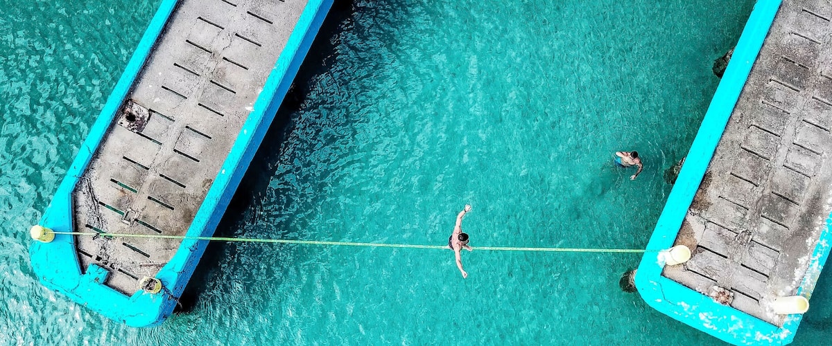 Crash Boat beach in Aguadilla, Puerto Rico is one of my favorite spots when I am in Puerto Rico. The beach took a massive hit from Hurricane Maria, but the locals banded together and did a great job clearing debris. Some creative kids set up a slack line over the water for all to try. #bvsblue